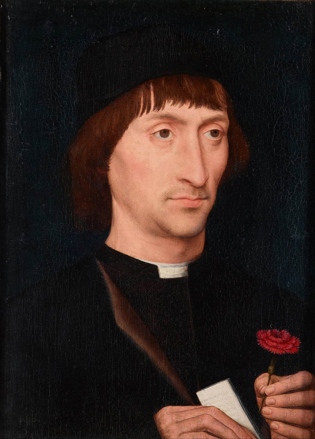 Portrait of a Man with a Pink by Hans Memling — A man in black holds a red carnation and a folded note
