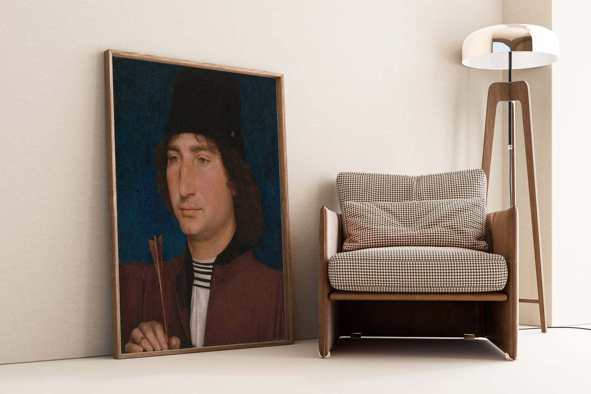 Framed art print of Portrait of a Man with an Arrow by Hans Memling, leaning against a wall beside an armchair and a floor lamp