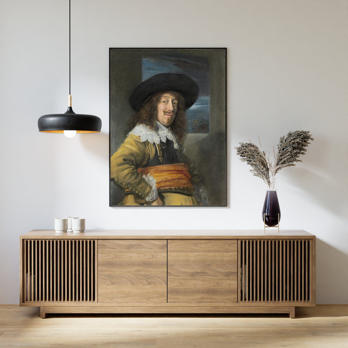 Framed art print of Portrait of a Member of the Haarlem Civic Guard by Frans Hals, above a slatted wood sideboard
