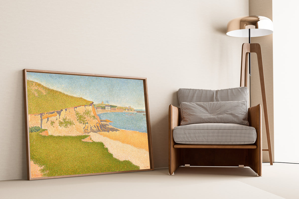 Framed art print of Portrieux, Tertre Denis by Paul Signac, leaning against a wall beside an armchair and a floor lamp