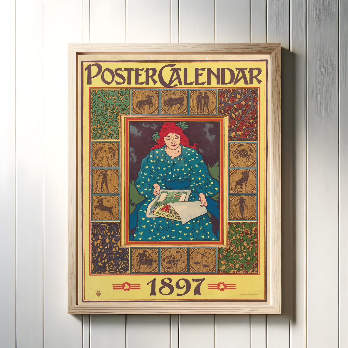 Framed art print of Poster Calendar, 1897 by Louis Rhead, in a light wood frame on a white panelled wall