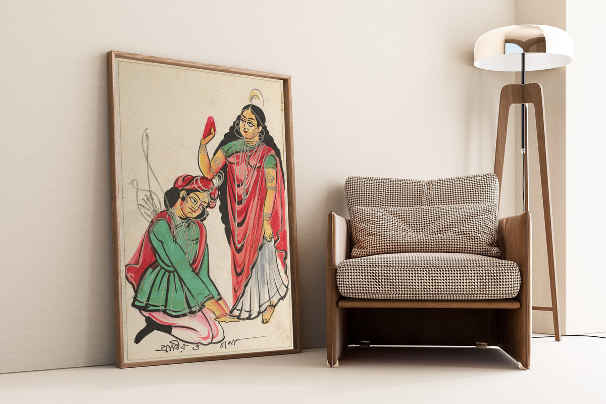 Framed art print of Pravira Kneeling at the Feet of Jana by Kalighat painter, leaning against a wall beside an armchair and a floor lamp
