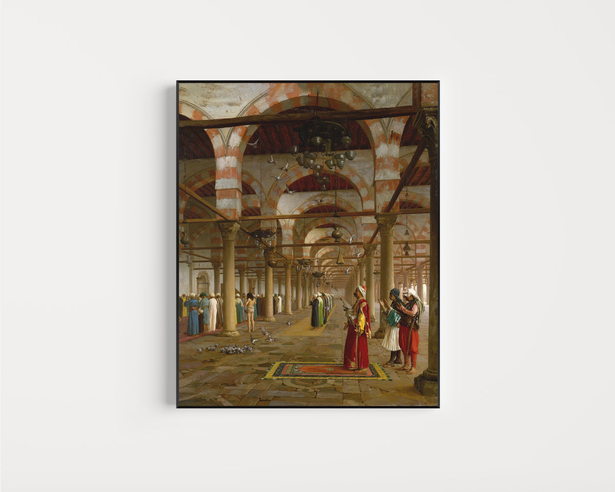 Framed art print of Prayer in the Mosque by Jean-Léon Gérôme, in a slim black frame on a plain white wall
