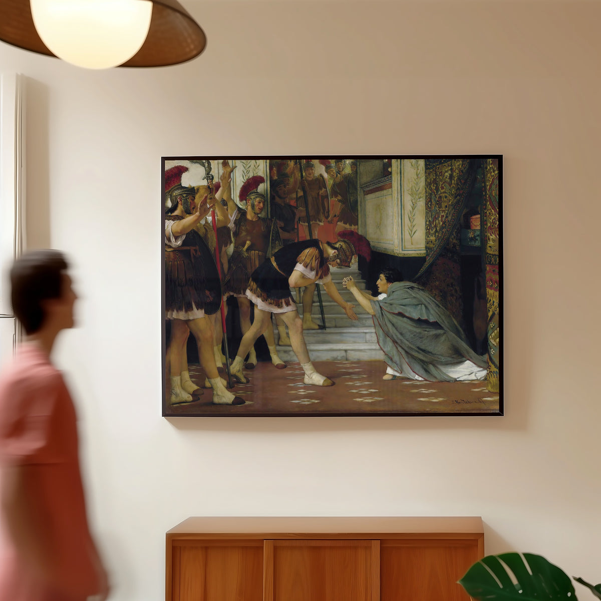 Framed art print of Proclaiming Claudius Emperor by Lawrence Alma-Tadema, in a slim black frame on a warm wall in a sunlit room