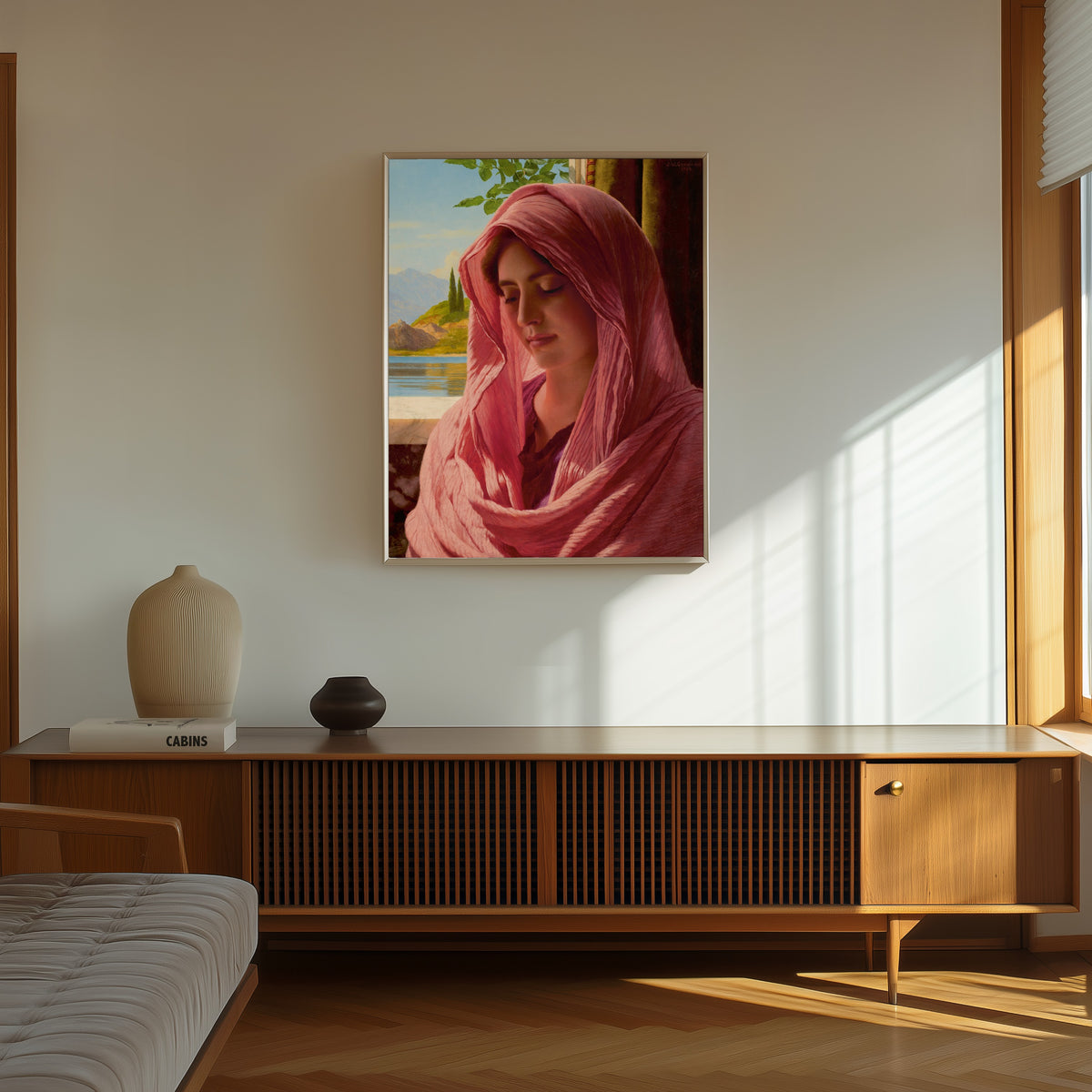 Framed art print of Pyrallis by John William Godward, in a thin light frame on a sunlit wall above a wooden sideboard