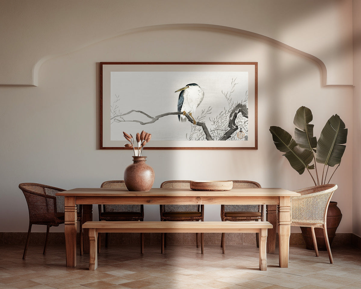 Night Heron on a Gnarled Branch by Ohara Koson — framed above a wooden dining table