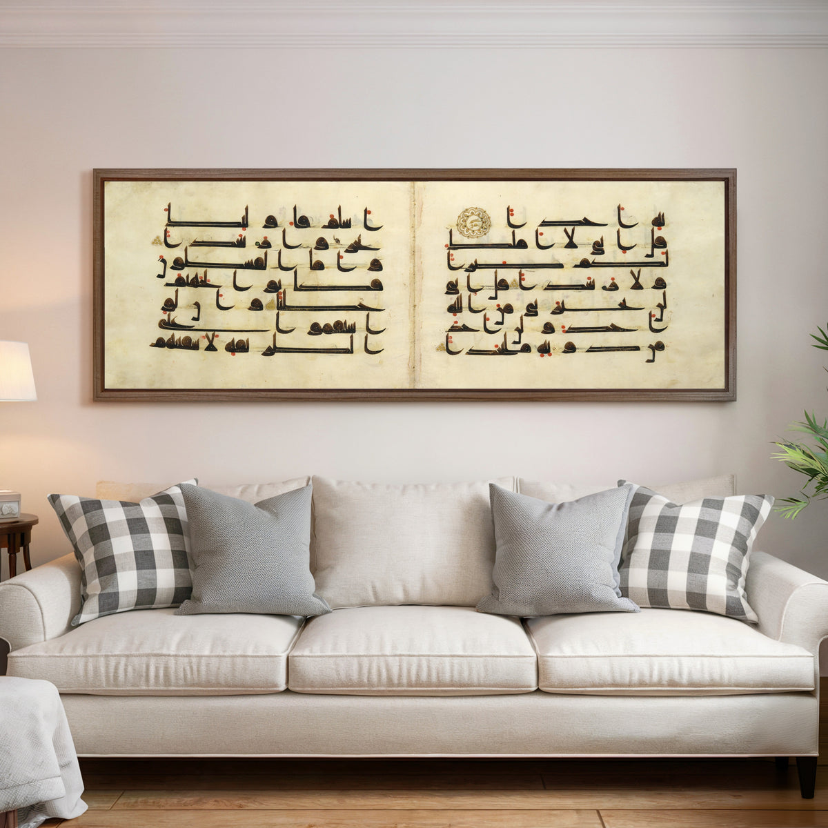 Framed art print of Qur'an Bifolium (Seven Lines on Parchment), above a cream sofa