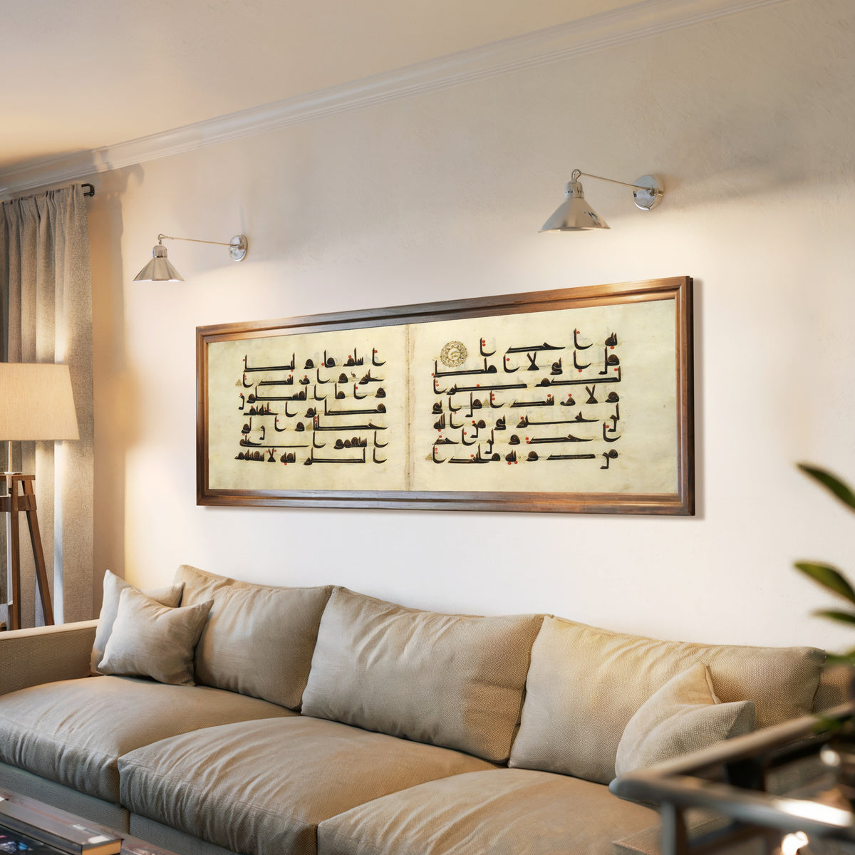 Framed art print of Qur'an Bifolium (Seven Lines on Parchment), above a long sofa with wall lights
