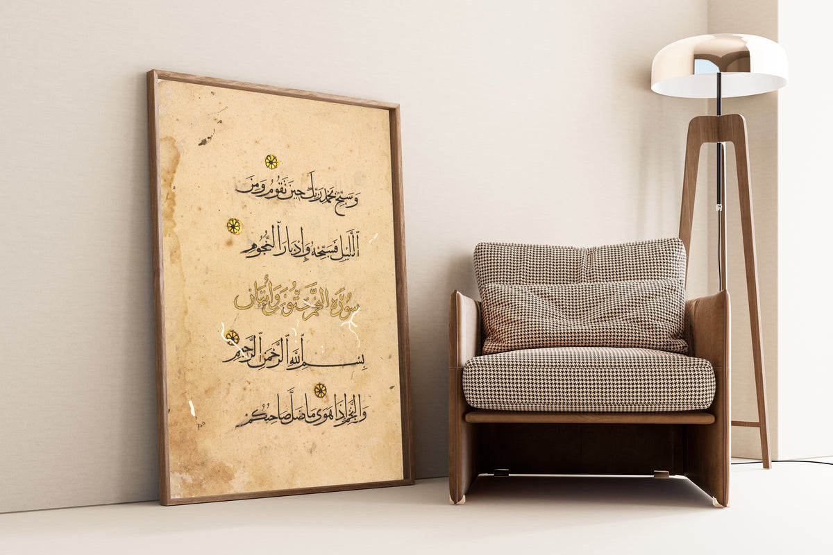Framed art print of Qur'an Folio: Suras al-Tur and al-Najm, leaning against a wall beside an armchair and a floor lamp