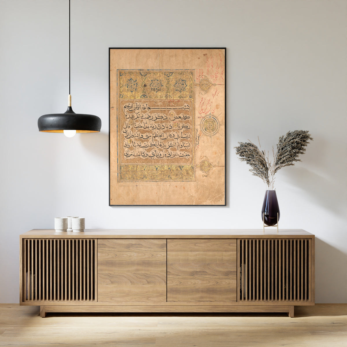 Framed art print of Qur'an Folio: Verses from Surat al-Maryam, above a slatted wood sideboard