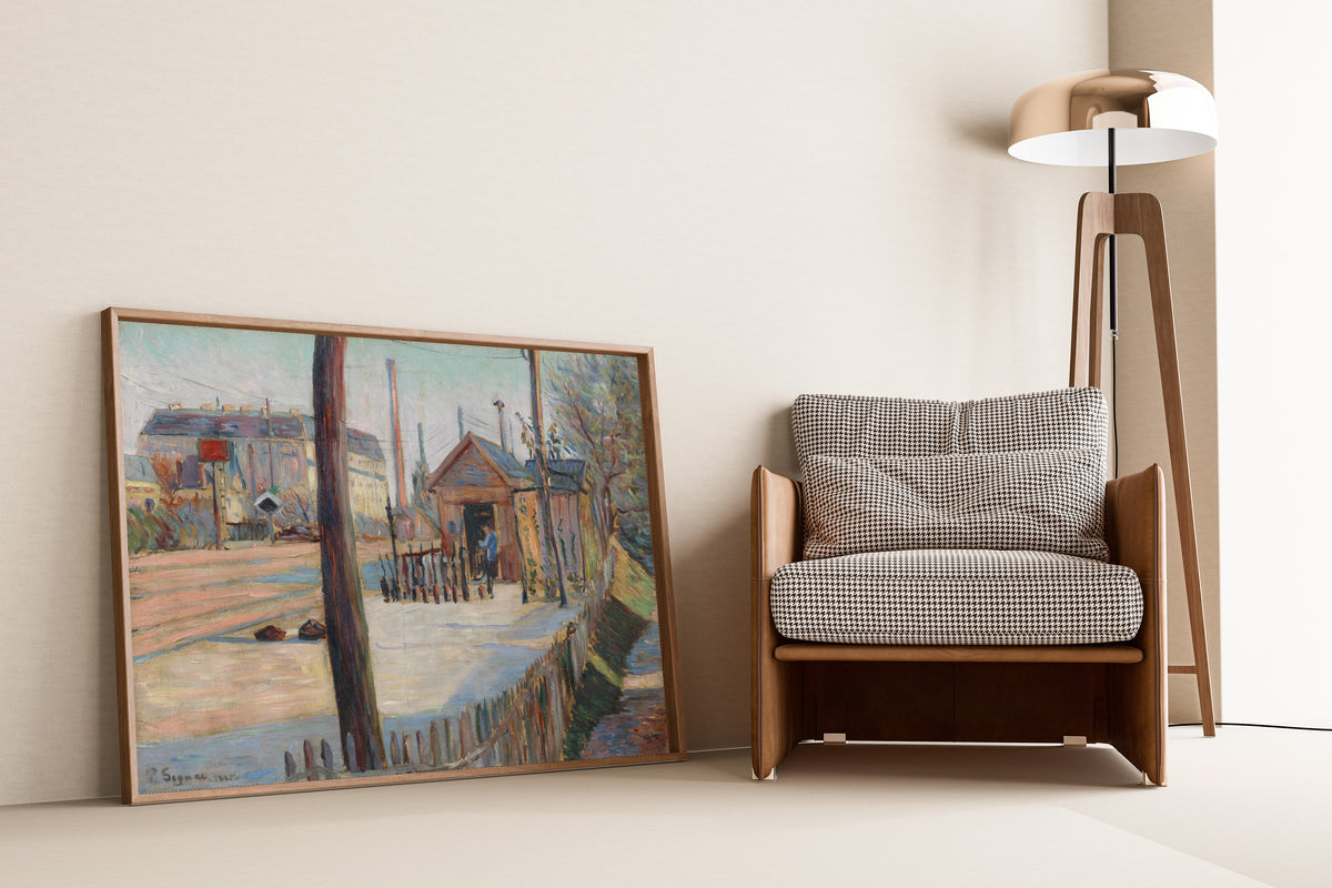 Framed art print of Railway Junction near Bois-Colombes by Paul Signac, leaning against a wall beside an armchair and a floor lamp