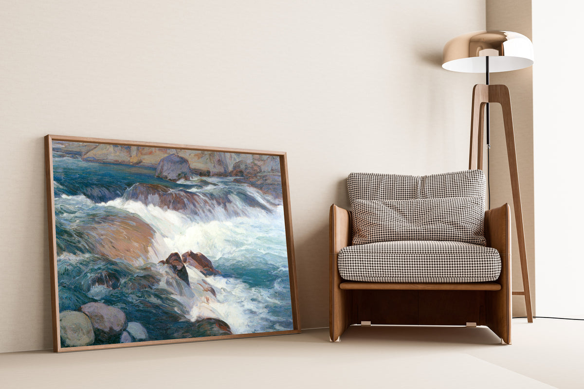 Framed art print of Rapid Stream by Hiroshi Yoshida, leaning against a wall beside an armchair and a floor lamp