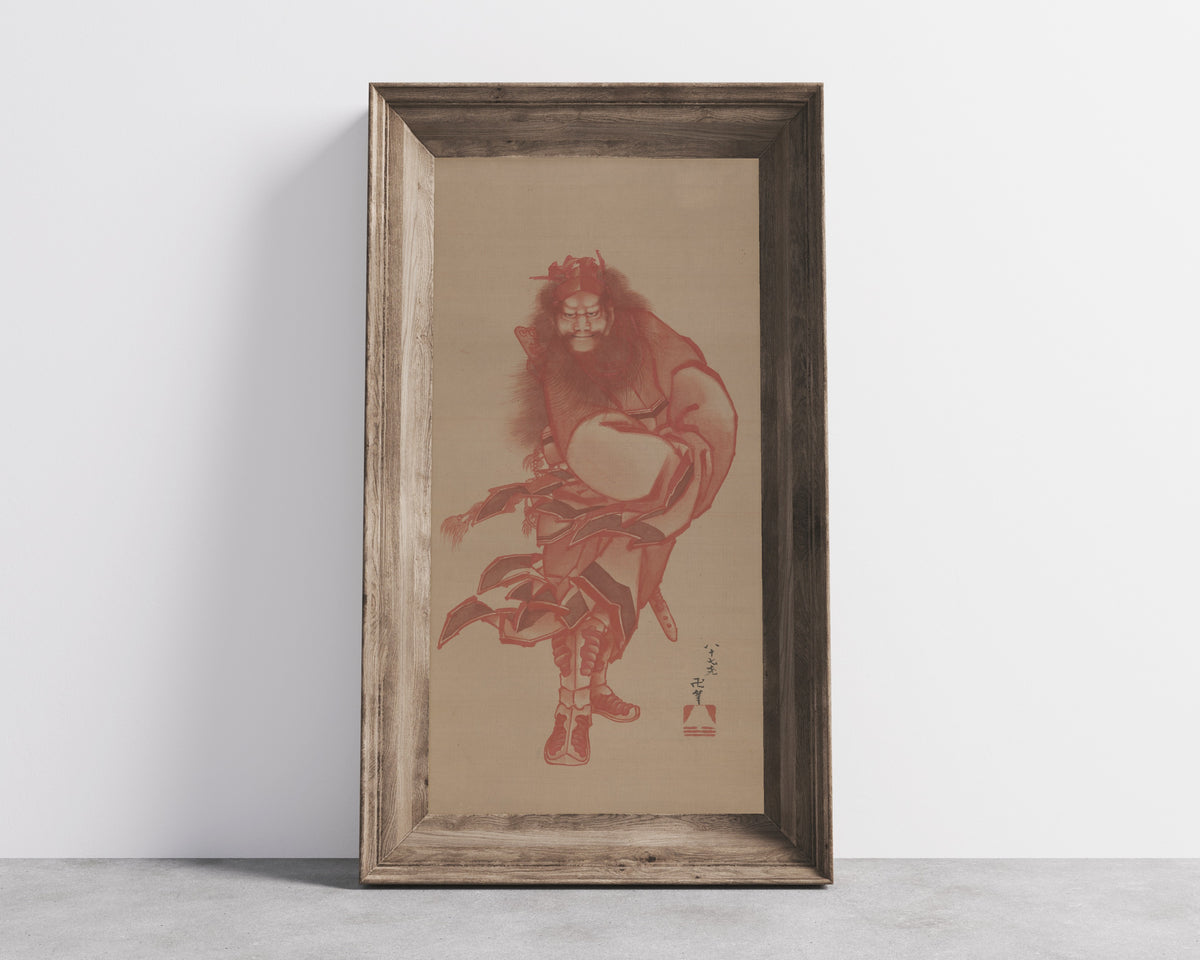 Framed art print of Red Zhong Kui, the Demon Queller by Katsushika Hokusai, in a wide wooden frame leaning against a concrete wall