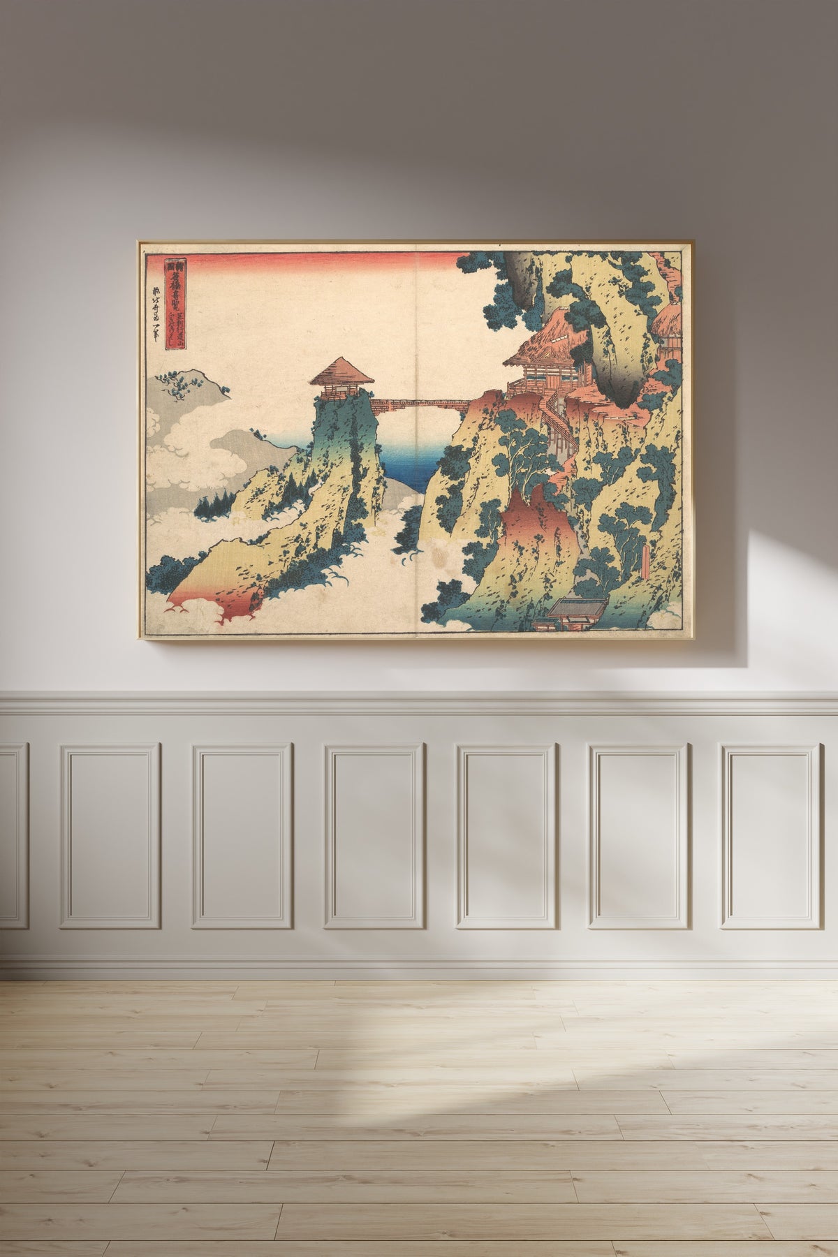 Framed art print of Remarkable Views of Bridges in Various Provinces: The Hanging-cloud Bridge at… by Katsushika Hokusai, on a panelled wall in afternoon light