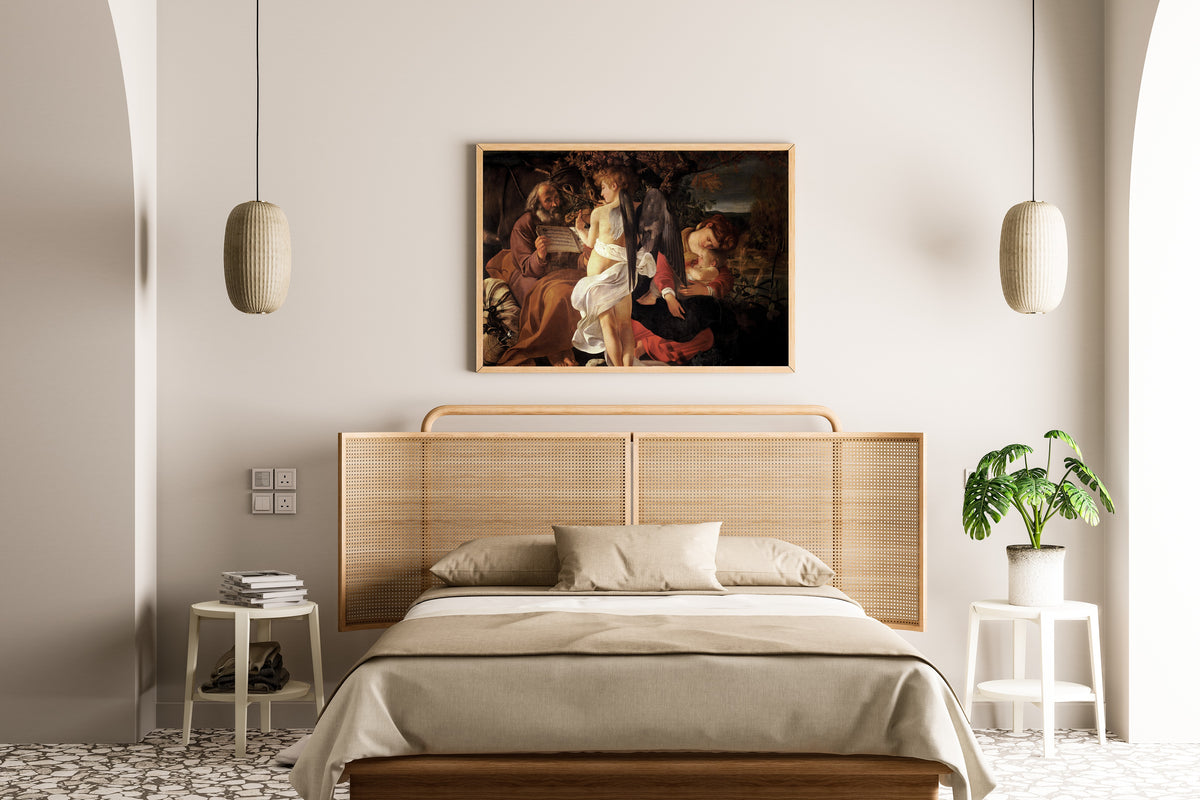 Framed art print of Rest on the Flight into Egypt by Caravaggio, above a cane-headboard bed