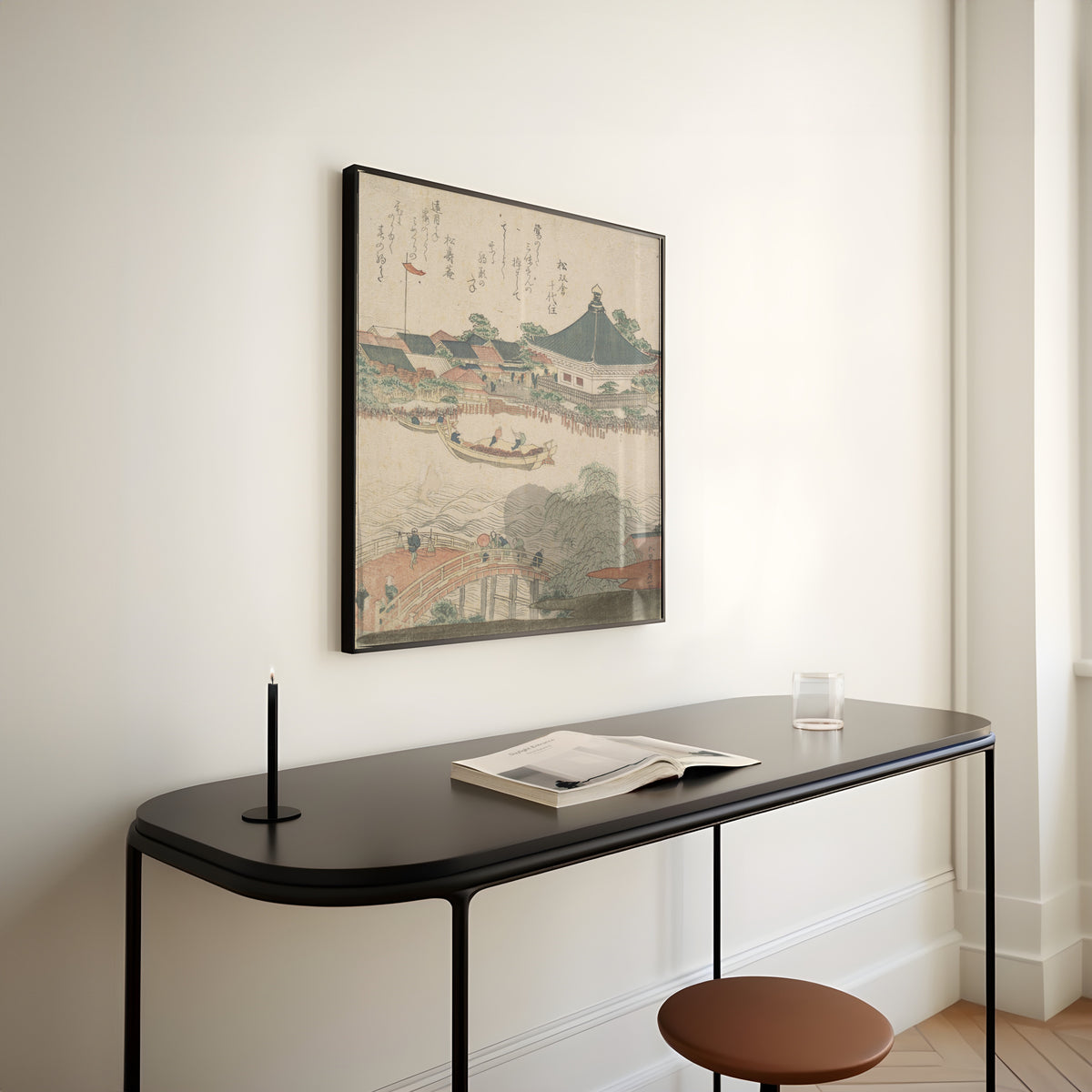 Framed art print of River Scene with Bridge in Foreground by Katsushika Hokusai, above a slim black console table