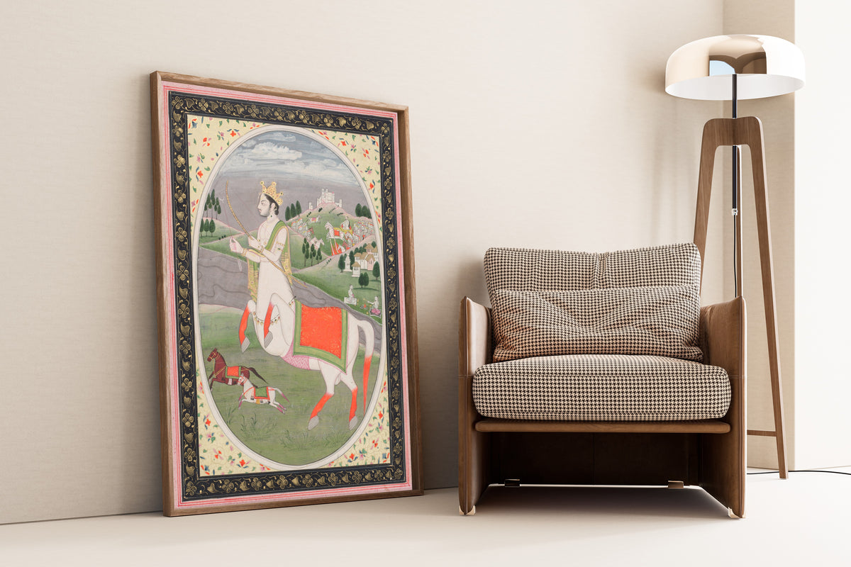 Framed art print of Sagittarius by Pahari school, leaning against a wall beside an armchair and a floor lamp
