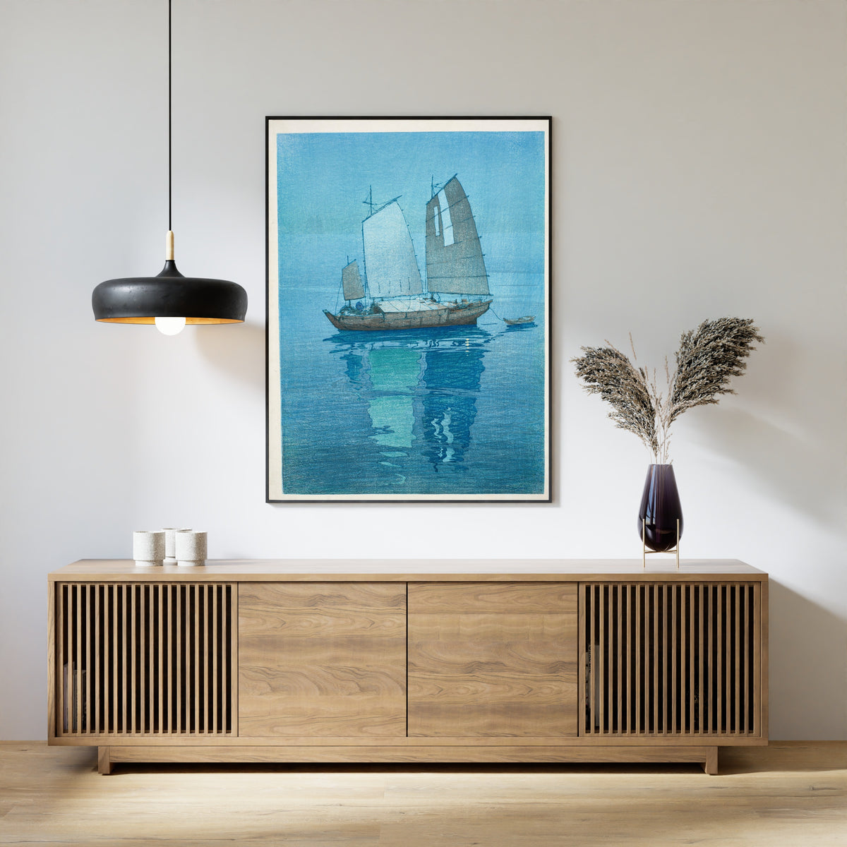 Framed art print of Sailing Boats by Hiroshi Yoshida, above a slatted wood sideboard