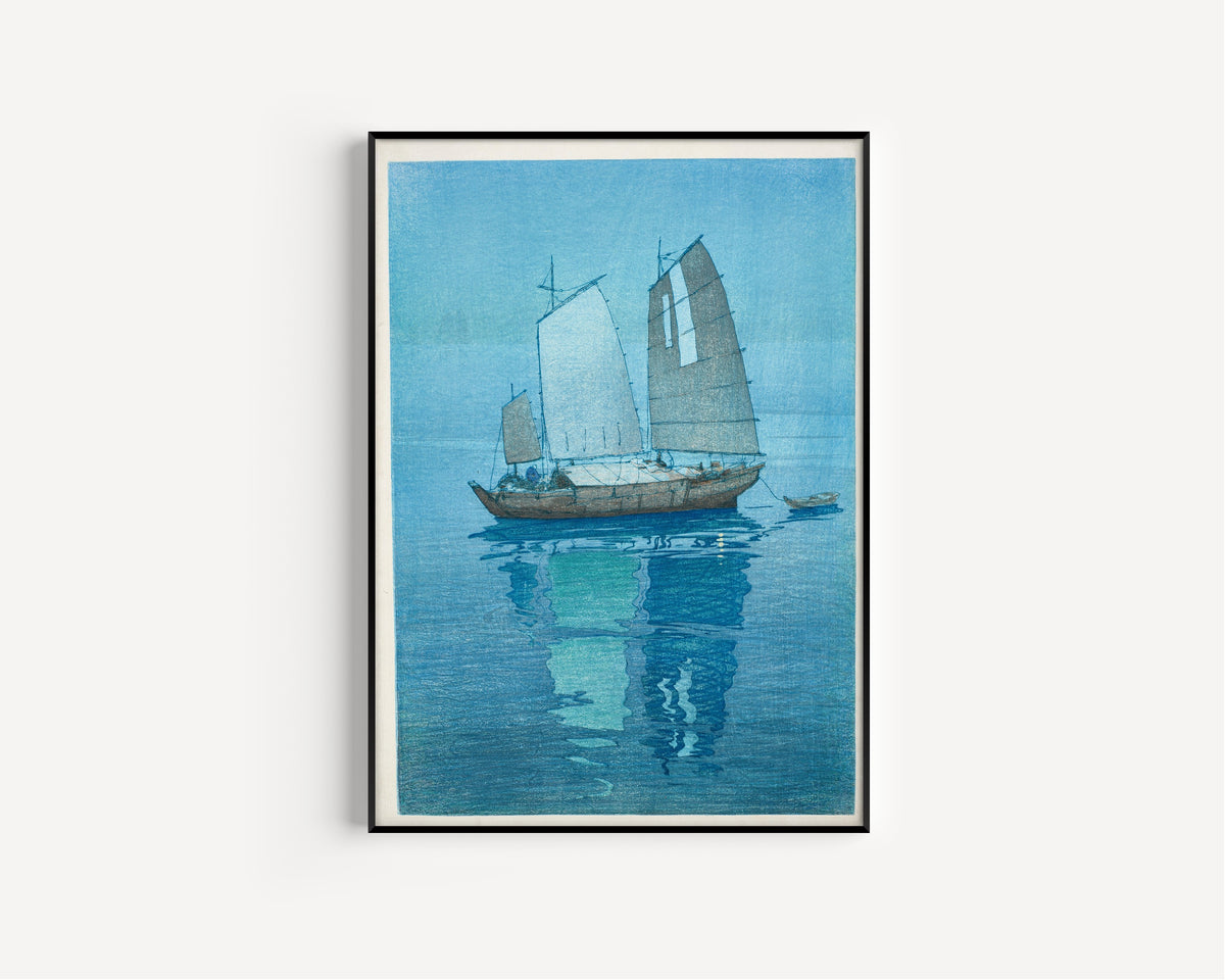Framed art print of Sailing Boats by Hiroshi Yoshida, in a slim black frame on a plain white wall