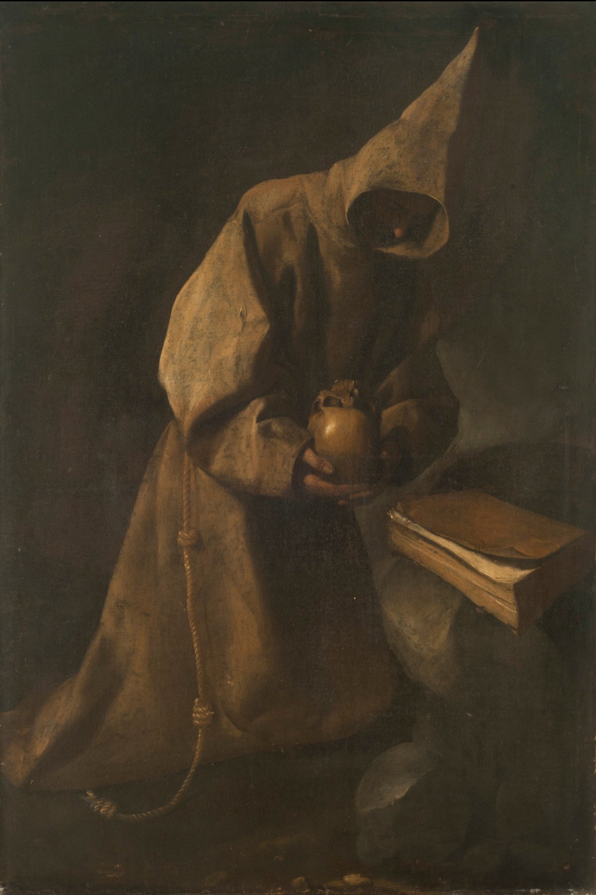 Saint Francis in Meditation by Francisco de Zurbarán — A hooded saint kneeling with a skull beside a closed book