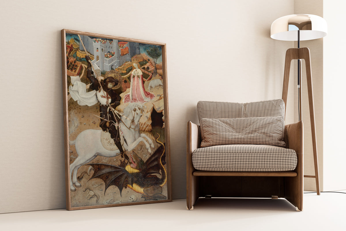 Framed art print of Saint George and the Dragon by Bernat Martorell, leaning against a wall beside an armchair and a floor lamp