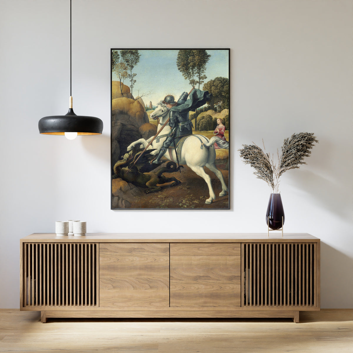 Framed art print of Saint George and the Dragon by Raphael, above a slatted wood sideboard