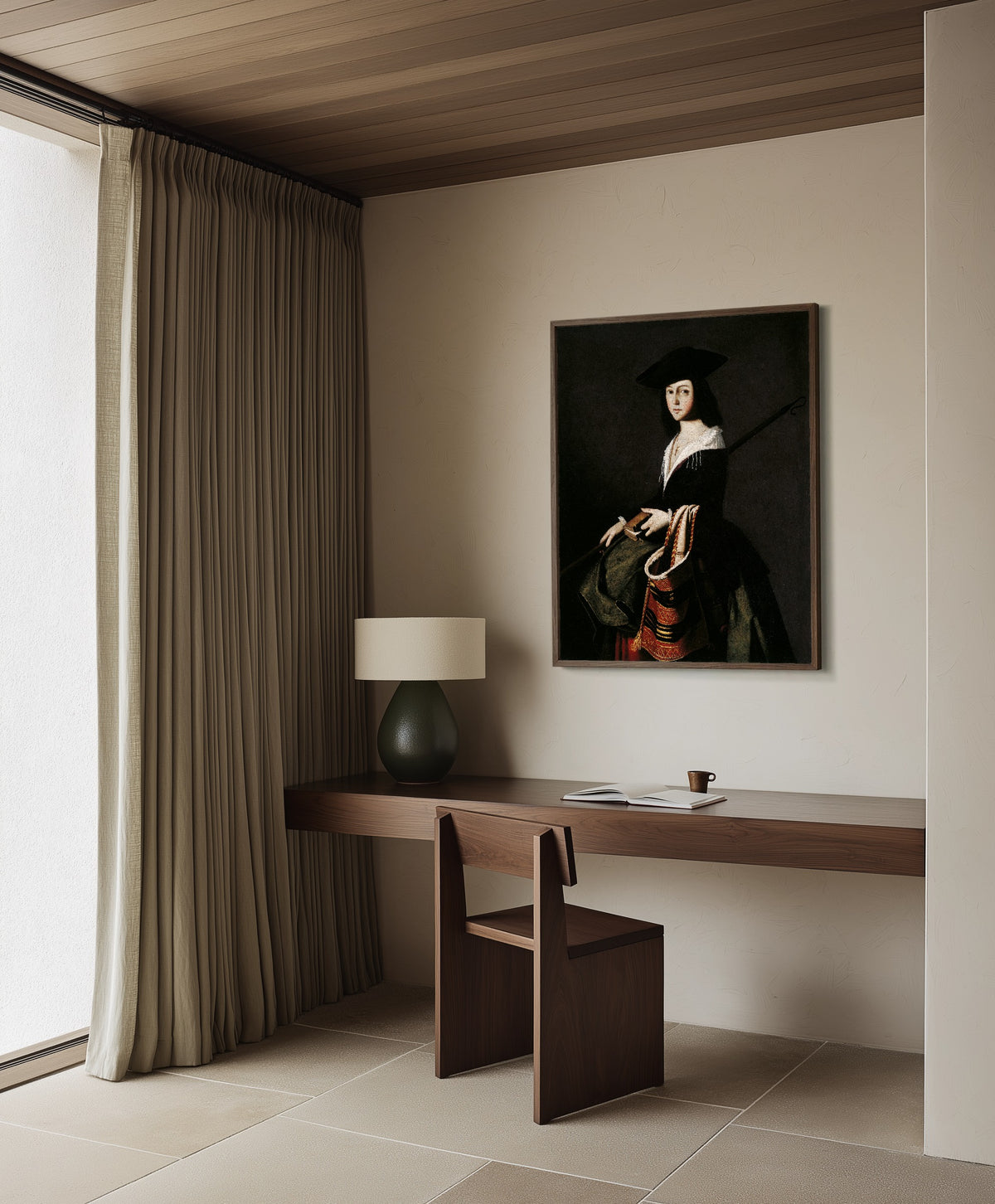 Framed art print of Saint Marina by Francisco de Zurbarán, in a dark wood frame on a plaster wall above a walnut desk