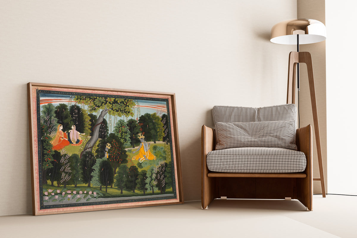 Framed art print of Sakhi Persuades Radha to Meet Krishna, from a Gita Govinda by Purkhu, leaning against a wall beside an armchair and a floor lamp