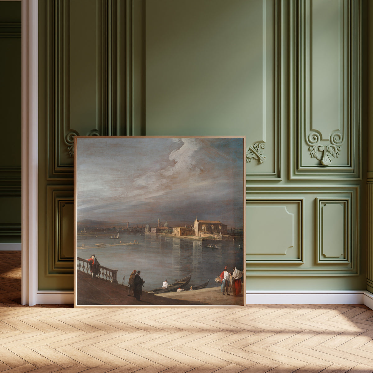 Framed art print of San Cristoforo, San Michele, and Murano from the Fondamenta… by Canaletto, leaning against olive-green panelling on a herringbone floor
