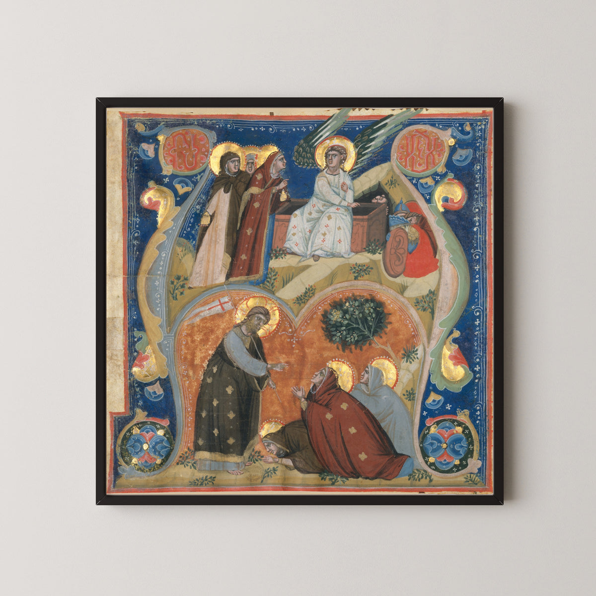 Framed art print of Scenes of Easter in an Initial A by Nerius, in a black frame on a pale wall