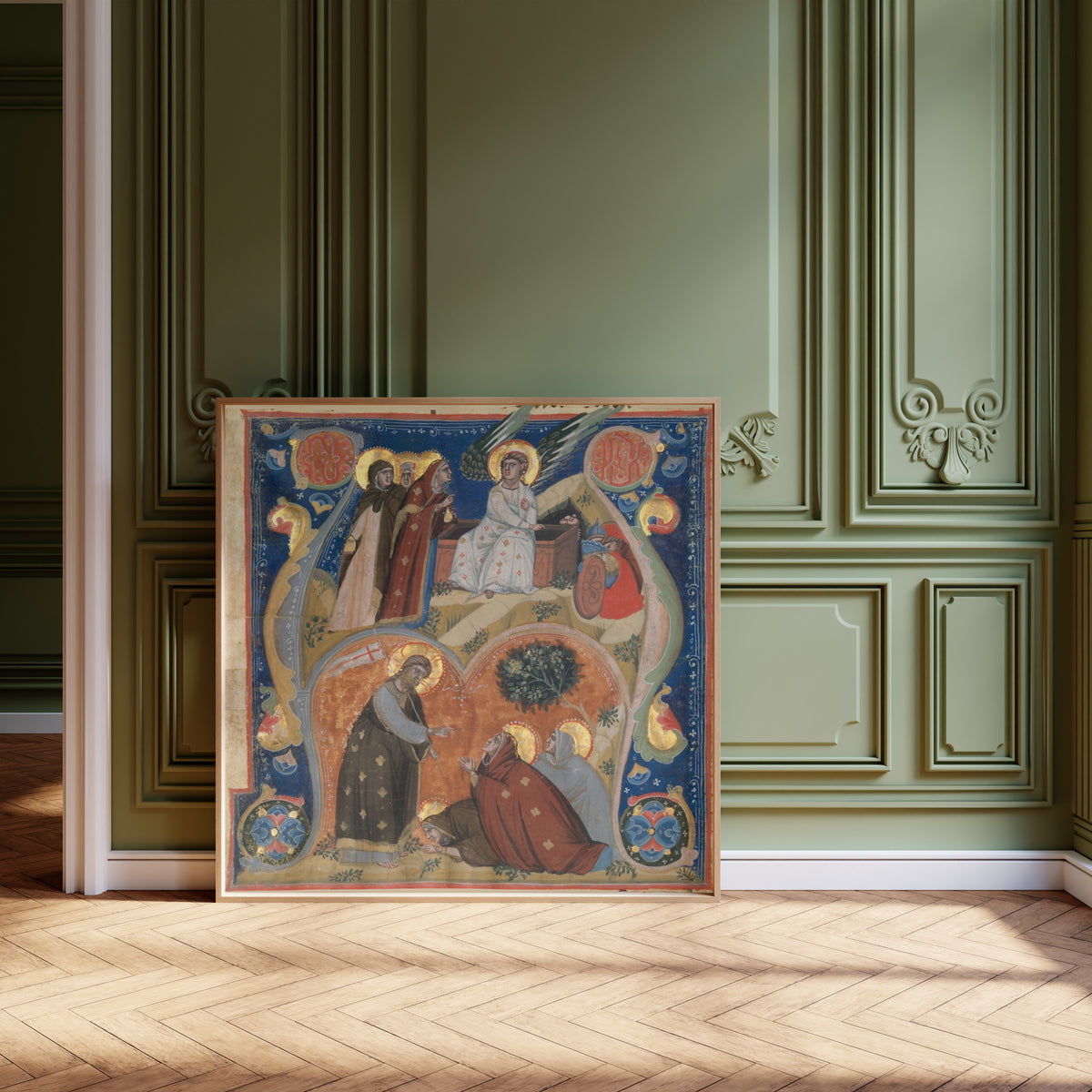Framed art print of Scenes of Easter in an Initial A by Nerius, leaning against olive-green panelling on a herringbone floor