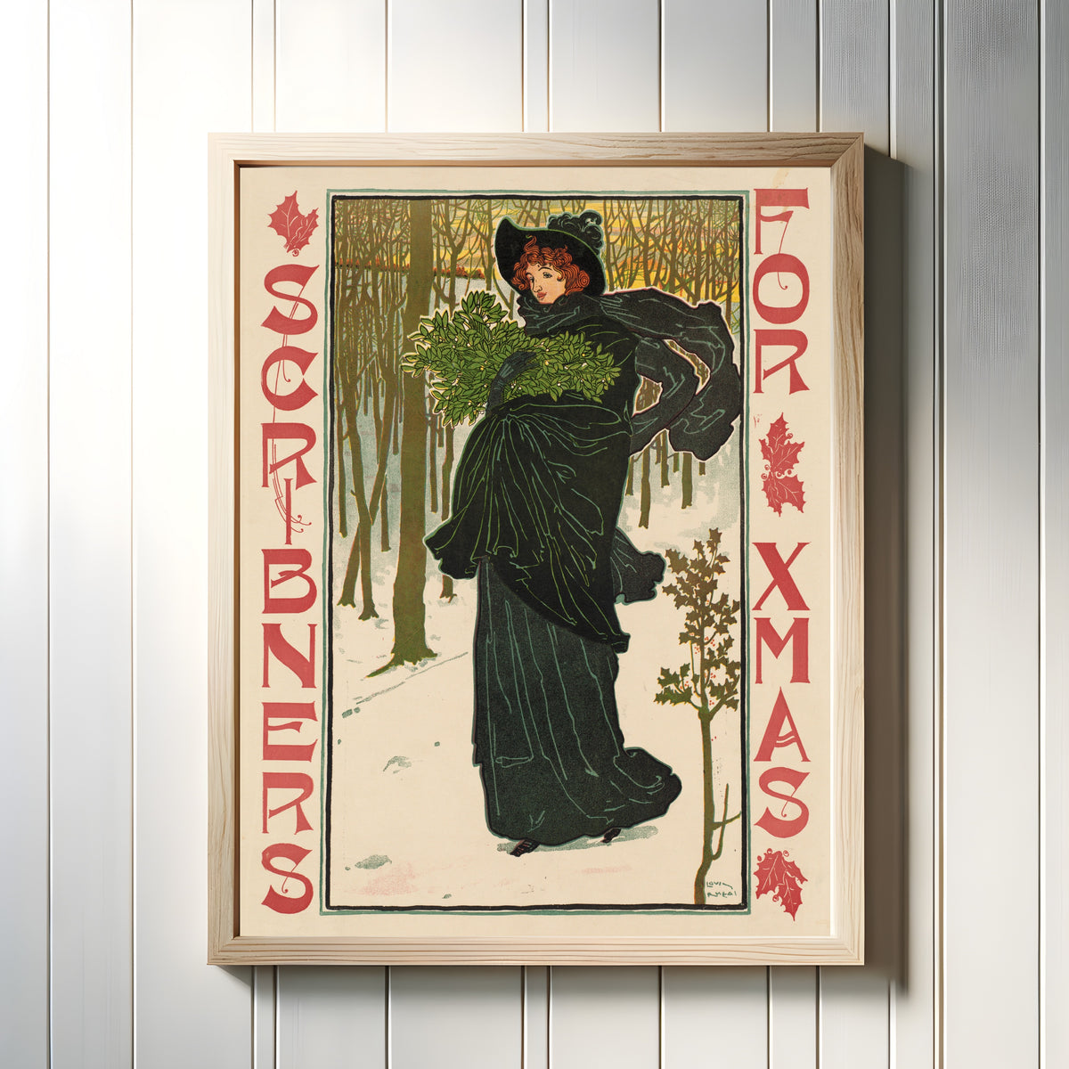 Framed art print of Scribner's for Xmas by Louis Rhead, in a light wood frame on a white panelled wall