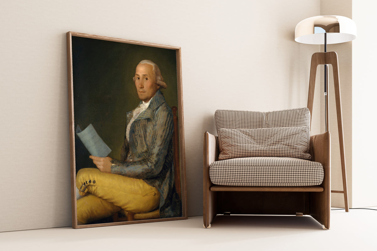 Framed art print of Sebastián Martínez y Pérez (1747–1800) by Francisco de Goya, leaning against a wall beside an armchair and a floor lamp