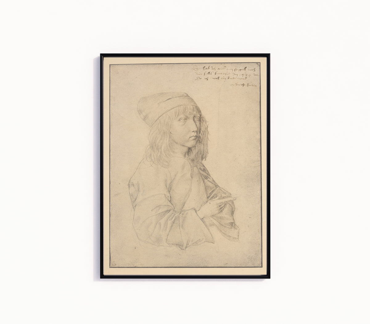 Framed art print of Self-Portrait at Thirteen by Albrecht Dürer, in a slim black frame on a plain white wall