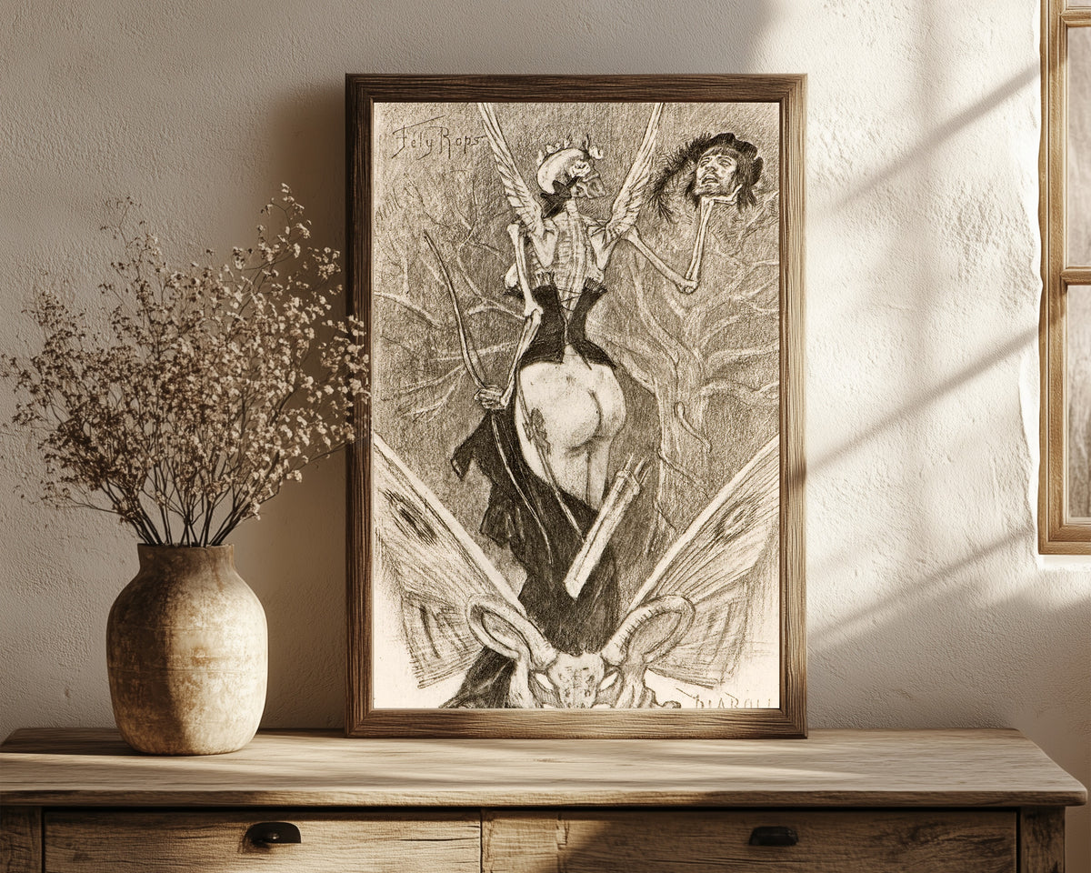 Framed art print of Sentimental Initiation by Félicien Rops, in a dark wood frame leaning on a rustic console beside dried flowers