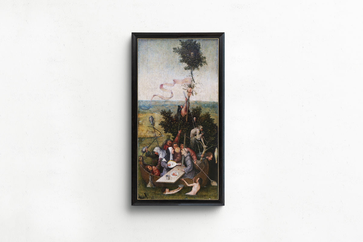 Framed art print of Ship of Fools by Hieronymus Bosch, in a slim black frame on a plain white wall