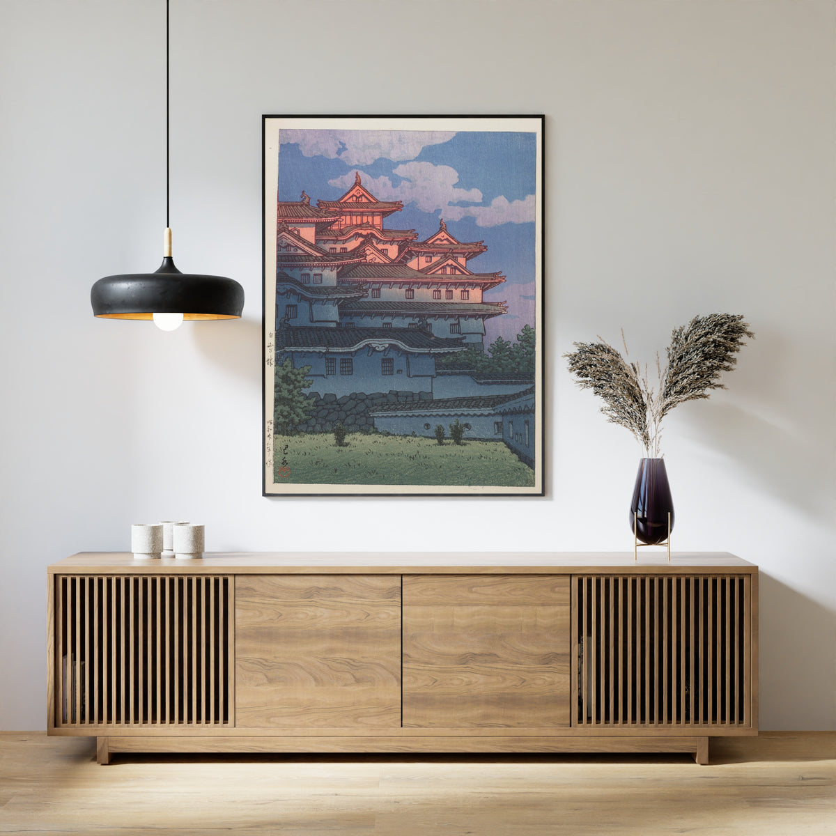 Framed art print of Shirasagi Castle by Kawase Hasui, above a slatted wood sideboard
