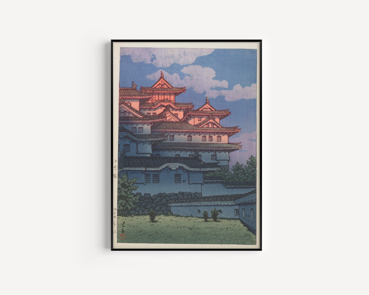 Framed art print of Shirasagi Castle by Kawase Hasui, in a slim black frame on a plain white wall