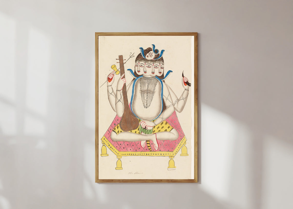 Framed art print of Shiva with Five Faces by Kalighat painter, in a light wood frame on a sunlit white wall