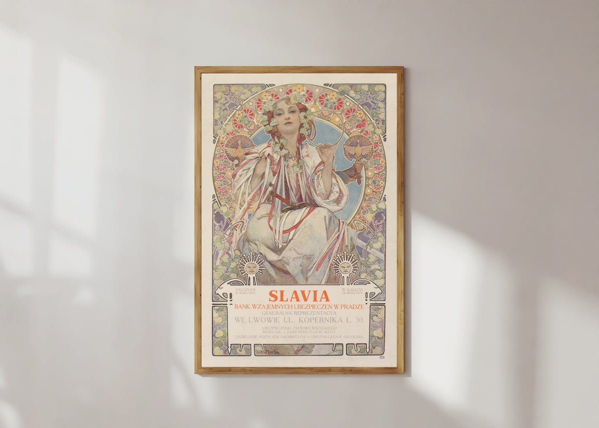 Framed art print of Slavia, Bank Wzajemnych Ubezpieczeń w Pradze by Alphonse Mucha, in a light wood frame on a sunlit white wall