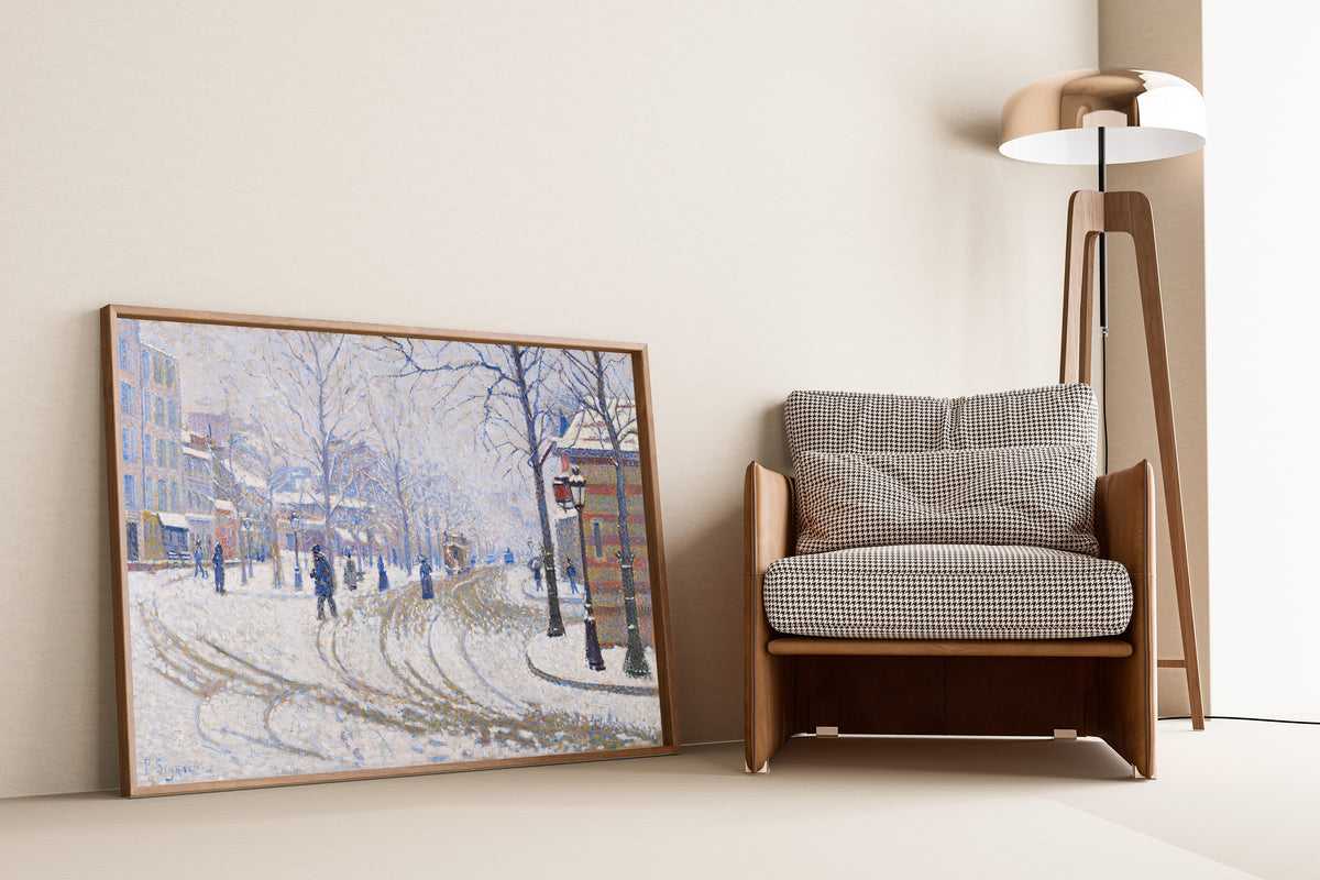 Framed art print of Snow, Boulevard de Clichy, Paris by Paul Signac, leaning against a wall beside an armchair and a floor lamp