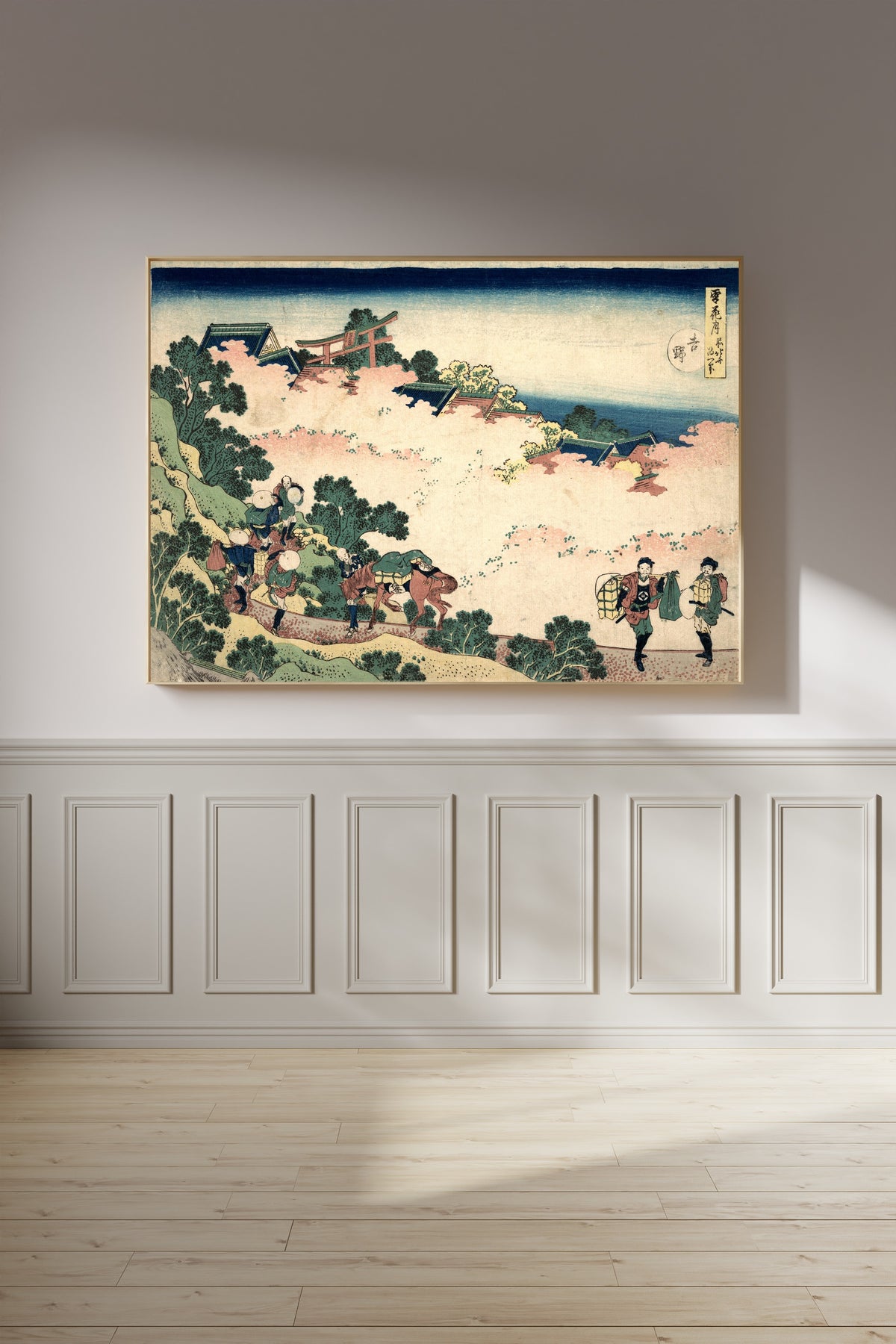 Framed art print of Snow, Moon and Flowers: Yoshino by Katsushika Hokusai, on a panelled wall in afternoon light