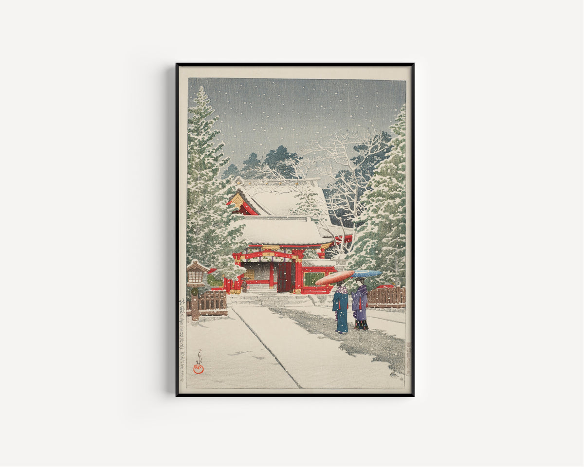 Framed art print of Snow at Hie Shrine by Kawase Hasui, in a slim black frame on a plain white wall