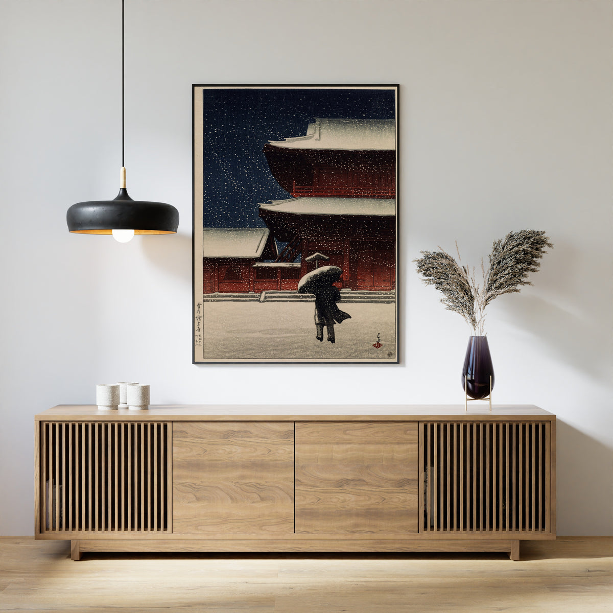 Framed art print of Snow at Zojoji Temple (1922) by Kawase Hasui, above a slatted wood sideboard