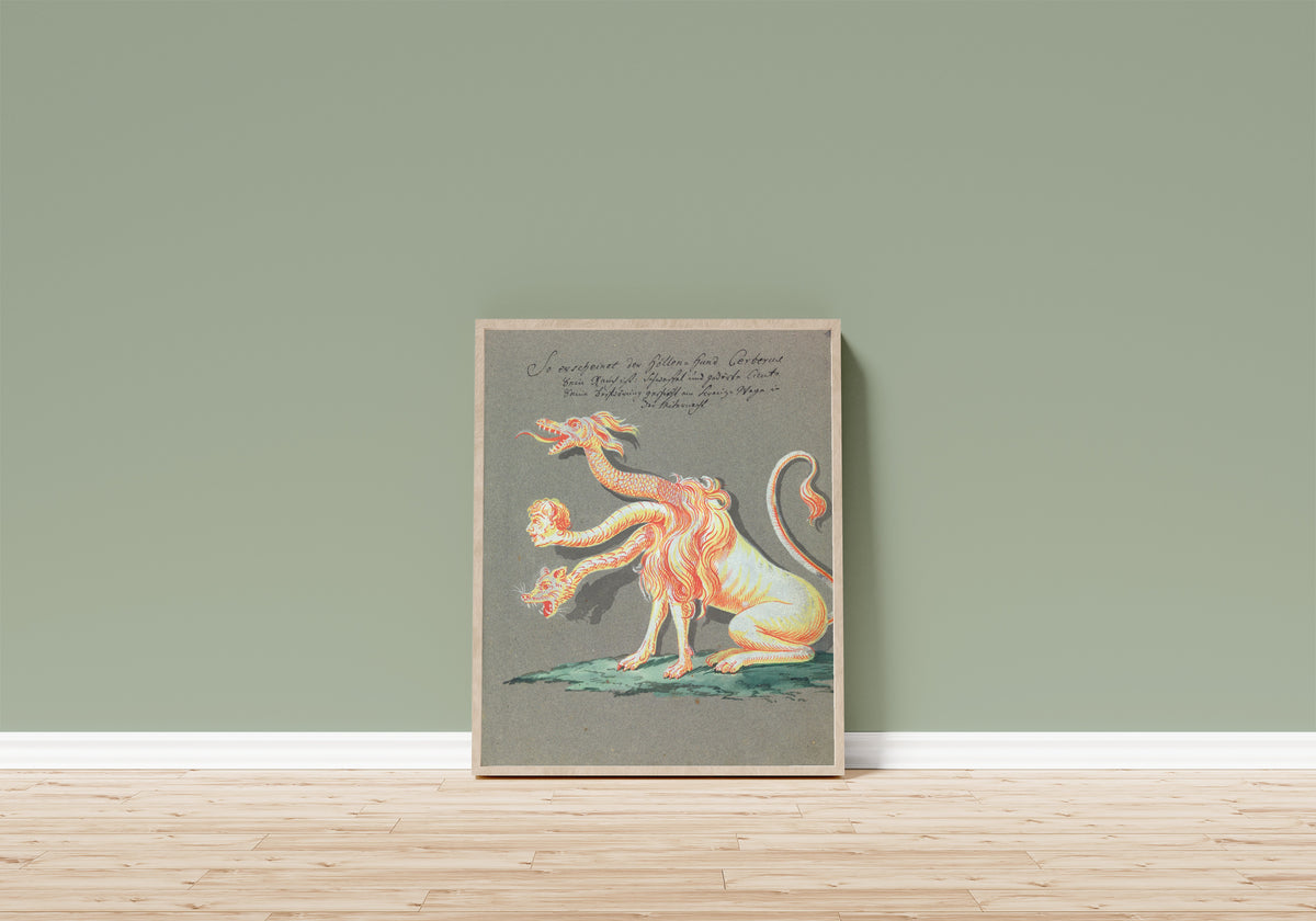 Framed art print of So erscheinet der Höllen-Hund Cerberus by Unknown artist, in a light wood frame leaning on a sage green wall above a wooden floor