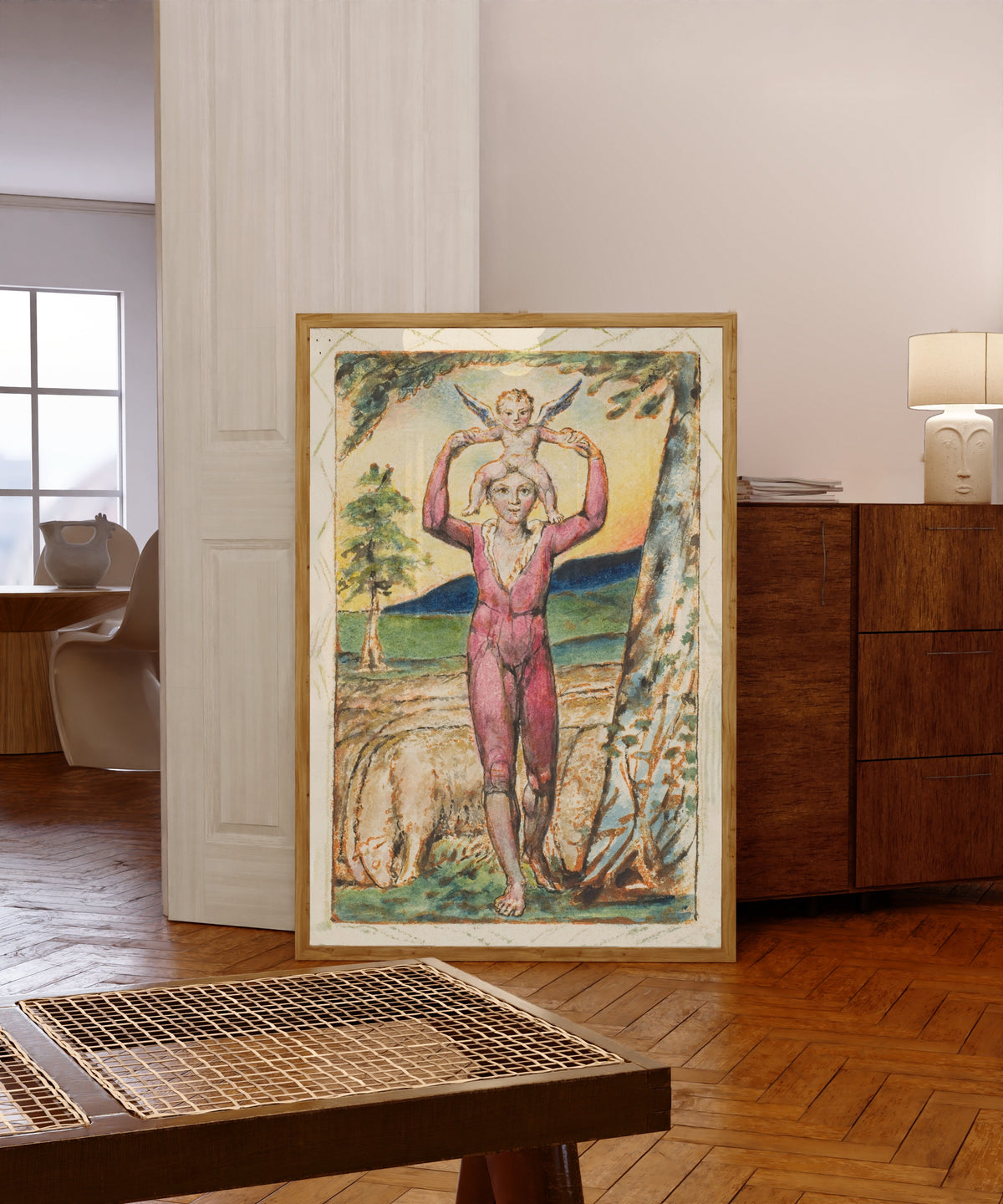 Framed art print of Songs of Experience: Frontispiece by William Blake, in a light wood frame leaning in a warm room with a parquet floor