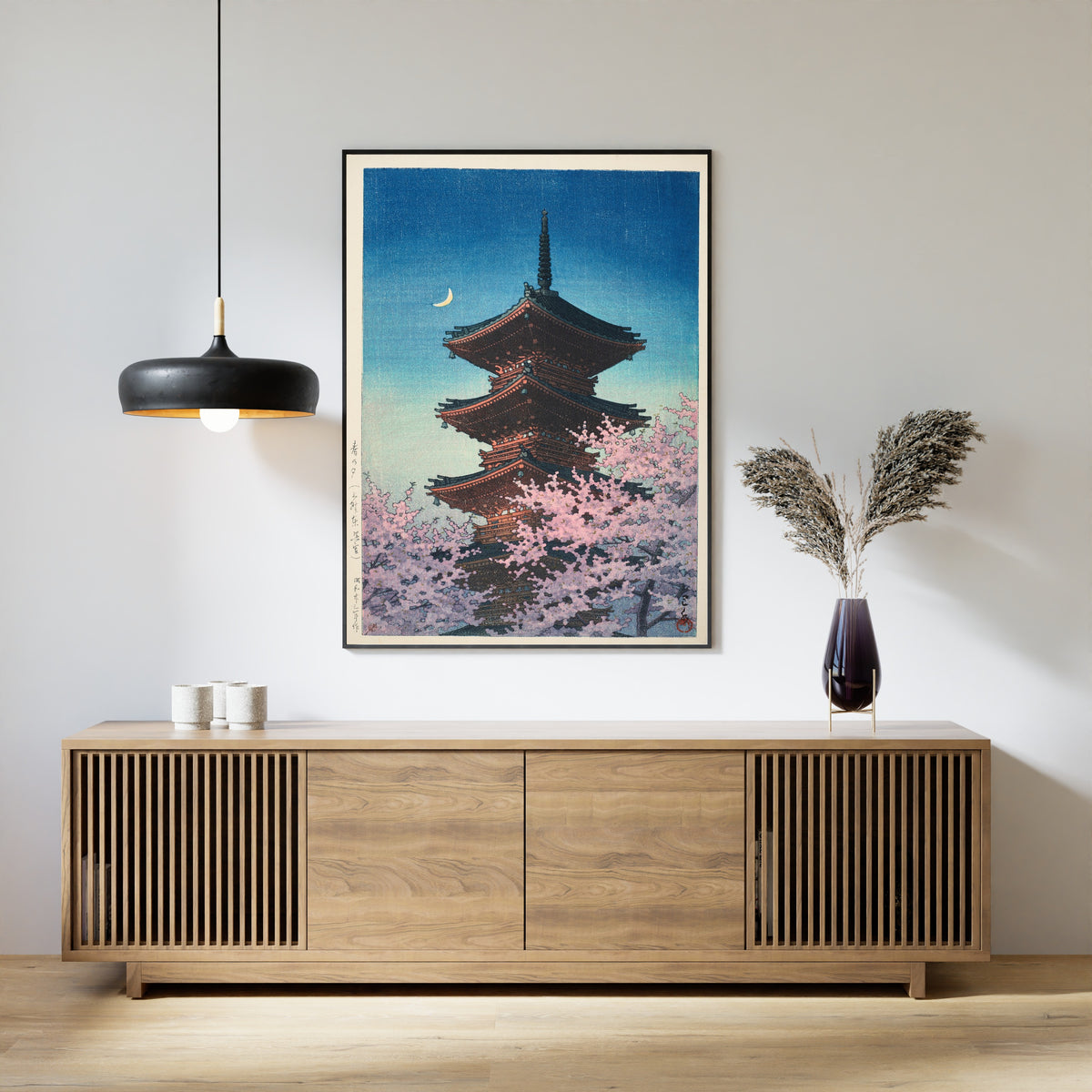 Framed art print of Spring Evening at Toshogu in Ueno by Kawase Hasui, above a slatted wood sideboard