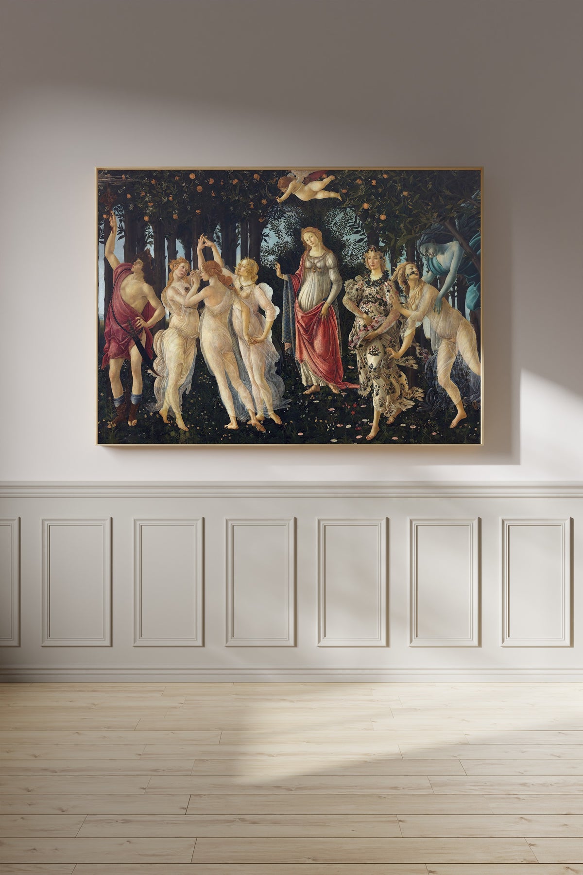 Framed art print of Spring by Sandro Botticelli, on a panelled wall in afternoon light