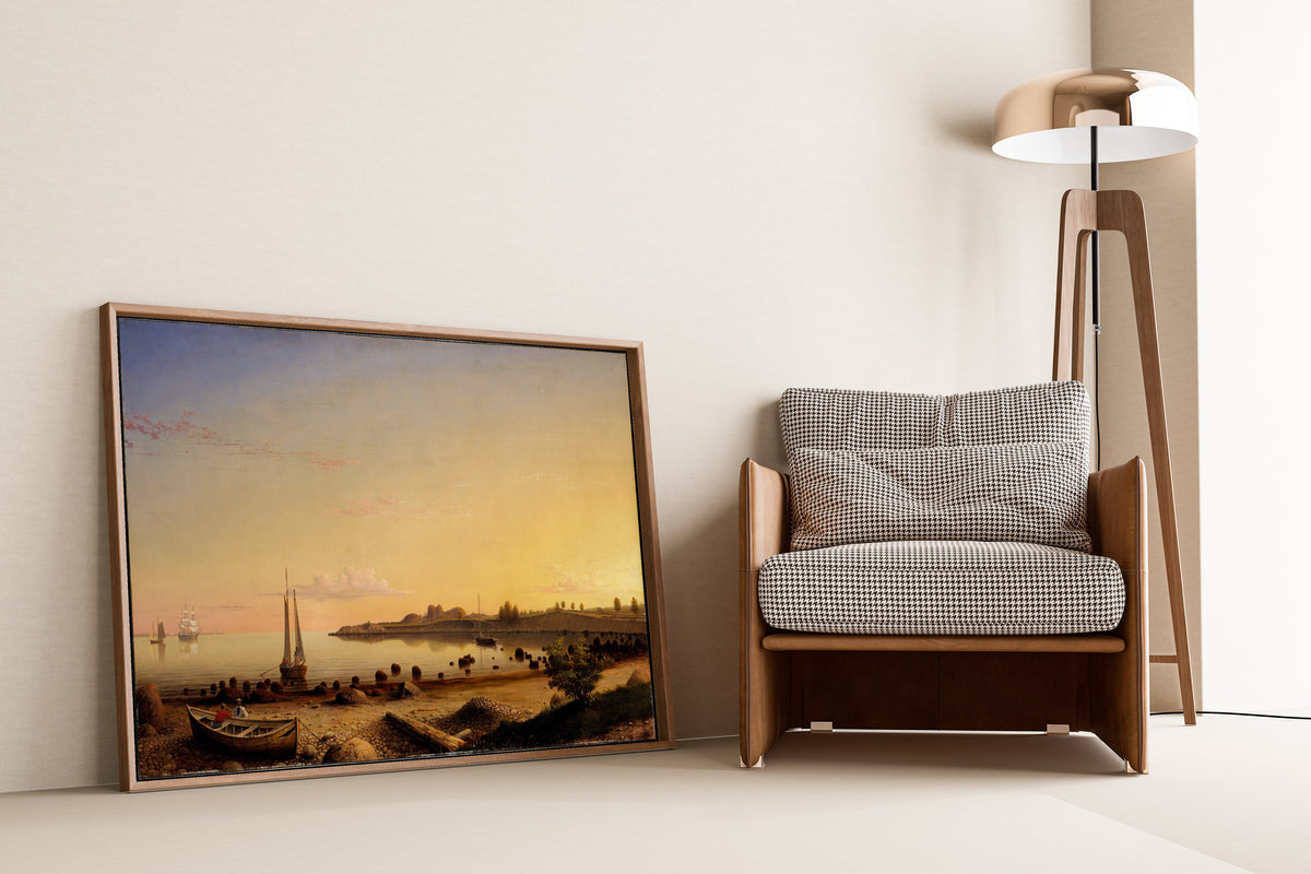 Stage Fort across Gloucester Harbor by Fitz Henry Lane — framed and leaning against a wall beside an armchair and a floor lamp