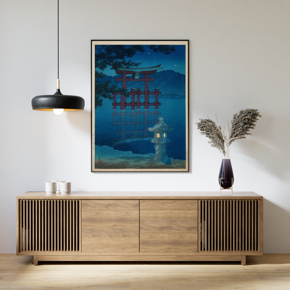 Framed art print of Starlit Night at Miyajima by Kawase Hasui, above a slatted wood sideboard